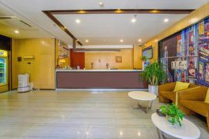 a lobby with a bar in the middle of a building at IU Hotel Taiyuan Changfeng West Street The Mixc in Taiyuan