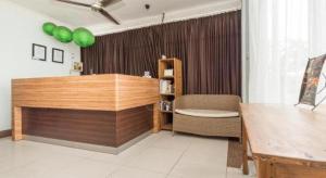 a room with a desk and a chair and a table at The Studio Inn Nusa Dua in Nusa Dua