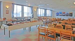 a large room with tables and chairs and windows at Spa Land Hotel Naito in Fuefuki +131 photos