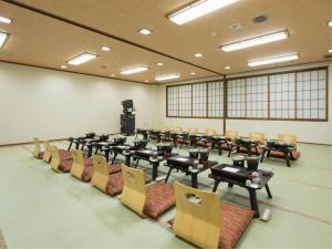 a large room with chairs and tables in a classroom at Yuzawa New Otani in Yuzawa +181 photos