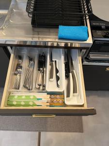 a drawer filled with utensils on a table at CatNook 猫ちぐら in Matsumoto