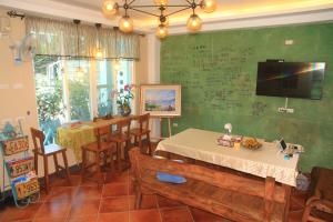 a dining room with a table and chairs and a chalkboard at 500Km Home in Hualien City