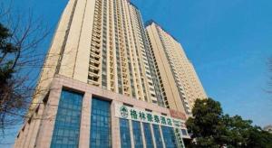 a tall white building with a lot of windows at GreenTree Inn Hefei Huangshan Road Business Hotel in Hefei