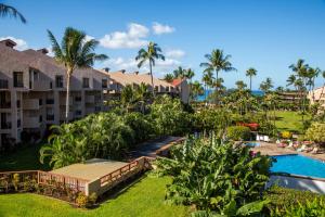 an aerial view of a resort with a pool and palm trees at Castle Kama'ole Sands in Wailea