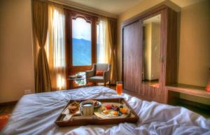 a tray of food on a bed in a hotel room at The Pema by Realm in Thimphu +173 photos