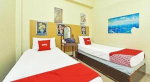 Postel nebo postele na pokoji v ubytování SPOT ON 90625 Super Green Grass Hotel