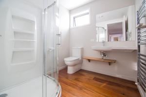 a bathroom with a toilet and a sink and a shower at Mackenzie Crib in Lake Tekapo