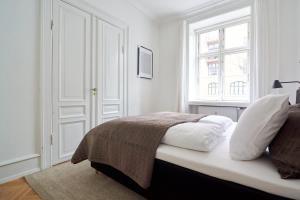 Ένα ή περισσότερα κρεβάτια σε δωμάτιο στο 2BR Oasis in the heart of CPH