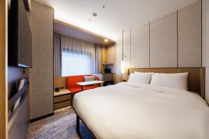 Postel nebo postele na pokoji v ubytování Hotel Metropolitan Edmont Tokyo