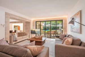 a living room with two couches and a table at Can Perot - Pollença in Pollença