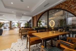 a restaurant with wooden tables and chairs at Old Stone Hotel Skopje in Skopje