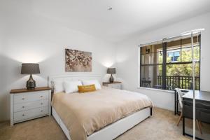 a bedroom with a bed and a desk and a window at Modern 2BR Cozy Apartment in Irvine in Lake Forest +20 photos