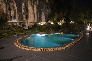 a swimming pool at a resort at night at Trang An Ecorest Resort & Spa in Xuân Sơn