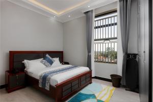 Ένα ή περισσότερα κρεβάτια σε δωμάτιο στο Beal Mall & Hotel