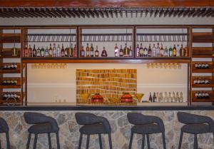 a bar with stools in front of a fireplace at Wellworth Mikumi Wildlife Lodge in Morogoro