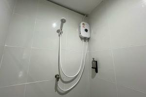 a shower in a bathroom with a blow dryer at Lazy Lizard Hostel in Ban Nong Chaeng