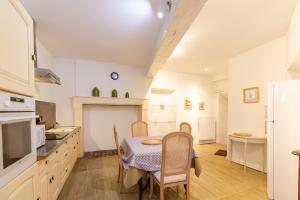 a kitchen with a table and chairs in a room at Charme et Elegance a Bourdeilles in Bourdeilles +13 photos