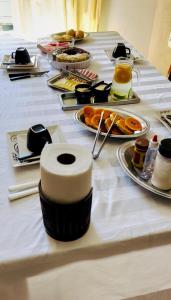 a table with a white table cloth with food on it at Suíte férias in Cabo Frio