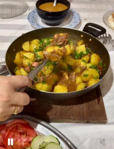 a person stirring a pan of food with a spatula at Suíte férias in Cabo Frio +4 photos