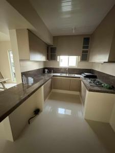 an empty kitchen with a sink and a stove at Solana Zaragoza house for lease in Capaya +1 photo