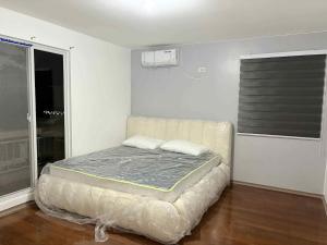 a bedroom with a bed in a room with a window at Solana Zaragoza house for lease in Capaya