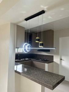 a kitchen with a granite counter top and two lights at Solana Zaragoza house for lease in Capaya