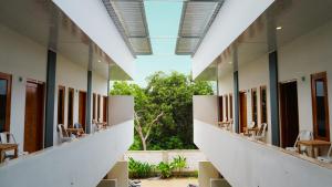 a row of tables and chairs in a building at Savira Golo Koe Labuan Bajo in Komodo Labuan Bajo Airport