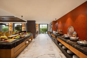 a buffet line in a restaurant with food on display at Courtyard by Marriott Bilaspur in Bilāspur