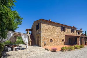 an external view of a stone house with a patio at La Fontaccia 13 by VacaVilla in Montiano +27 photos