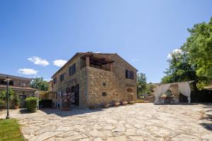 an old stone building with a tent in front of it at La Fontaccia 13 by VacaVilla in Montiano
