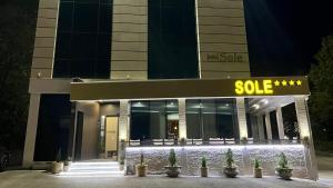 a sold sign in front of a building at night at Hotel Sole in Međugorje