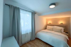 Кровать или кровати в номере Brunnalm Blick Apartment