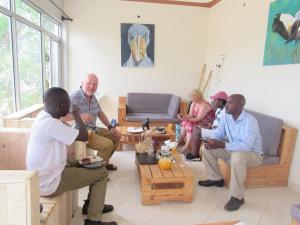 a group of people sitting in a living room at Mabamba shoebill Campsite in Ziba