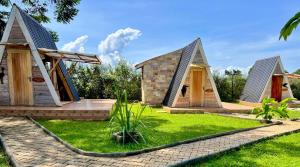 a group of three houses with their doors open at Mabamba shoebill Campsite in Ziba