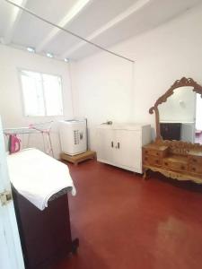 a white room with a bed and a mirror at Apartment no17 in Galle