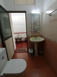 a small bathroom with a toilet and a sink at Apartment no17 in Galle