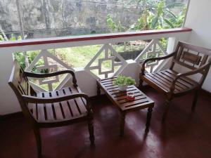 three chairs and a table in front of a window at Apartment no17 in Galle
