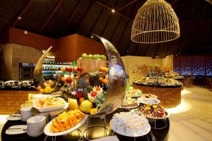 a buffet with many plates of food on a table at Centara Ras Fushi Resort & Spa Maldives - 50 percent discount on transfers for min 4 nights stay and more, valid for reservations between 11th Feb till 22 Dec 2025 in North Male Atoll
