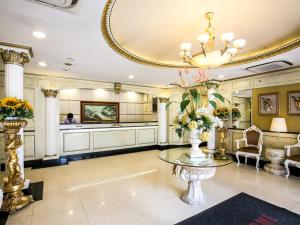 a large lobby with a table and a mirror at Hotel 81 Chinatown in Singapore