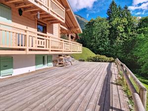 a large wooden deck in front of a house at Chalet Casimir CSM CHARMING & NATURE 10 Pers in Châtel