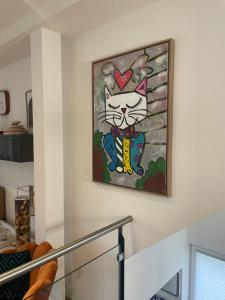 a painting of a cat on a wall at Your exclusive 2 room & 2 bathroom natural holiday home in Winterthur