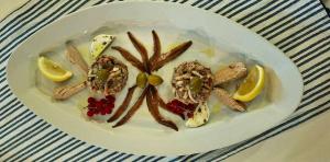 a white plate with food on a table at Sobe MaMaLu in Valun +59 photos