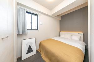 Voodi või voodid majutusasutuse Living like hotel Hakata Premium toas