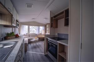 a kitchen with a sink and a stove top oven at Visby Strandby in Visby +54 photos