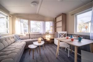 a living room with a couch and a table at Visby Strandby in Visby