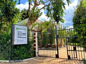 a gate with a sign in front of it at Nature Smart Center Mabamba in Ziba