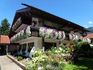 a house with flowers on the side of it at Landhaus Kränzle in Fischen