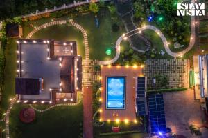 an overhead view of a house with lights at StayVista at The Red Creek with BBQ and Bonfire in Nagothna
