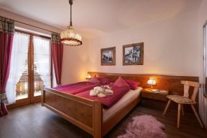 a bedroom with a bed with two teddy bears on it at Landhaus Kränzle in Fischen