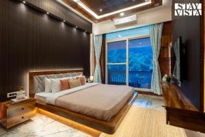 a bedroom with a bed and a large window at StayVista at The Red Creek with BBQ and Bonfire in Nagothna